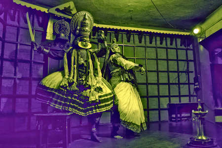 Kochi, India - March 15, 2014: An Indian classical dance form named Kathakali artists tells Indian mythological stories through numerous gestures techniques and emotions in front of several European tourists.のeditorial素材
