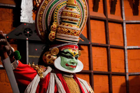 Kochi, India - March 15, 2014: An Indian classical dance form named Kathakali artists tells Indian mythological stories through numerous gestures techniques and emotions in front of several European tourists.のeditorial素材
