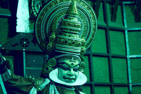 Kochi, India - March 15, 2014: An Indian classical dance form named Kathakali artists tells Indian mythological stories through numerous gestures techniques and emotions in front of several European tourists.のeditorial素材