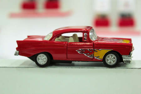 Close up a tiny random red toy hot wheel car