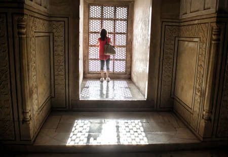 Agra, India - April 10,2014: A tourist inside Tajmahal dome and sun rays coming through windowsのeditorial素材