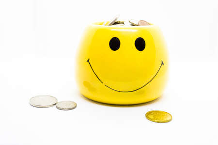 Image representing money saving and it's benefit by portraying coins in a yellow cup with smiley