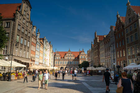 Gdansk, North Poland - August 13, 2020: Tourists walking next to neptune's fountain touristic spot...