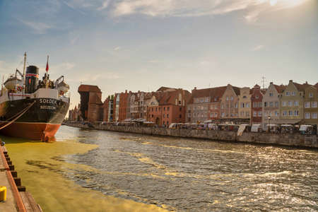 Gdansk, North Poland - August 13, 2020: Sunset Panoramic view of Summer around motlawa river adjacent to beautiful Polish architecture near baltic sea and ship docked on leftのeditorial素材