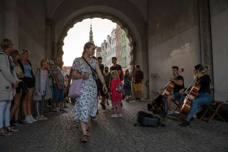 Gdansk, North Poland - August 13, 2020: Main city center restoring it's energy with tourists visiting and street performer musician with violin during covid timeのeditorial素材