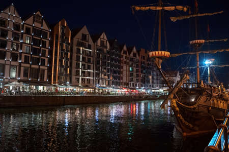 Gdansk, North Poland - August 13, 2020: Night photograph of medieval style polish architecture and a...