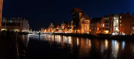 Gdansk, North Poland - August 15, 2020: Wide angle panoramic Night photography of polish cityscape with polish architecture in the old town over motlawa river near baltic seaのeditorial素材