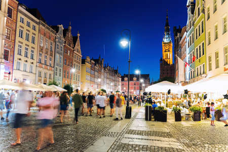 Gdansk, North Poland - August 15, 2020: Night photography of people walking in motion blurred in the old town of baltic city near motlawa river after quarantine was lifted just few days agoのeditorial素材