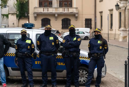 Krakow, Poland - October 25, 2020: Polish police on duty wearing mask during pandemic to maintain...