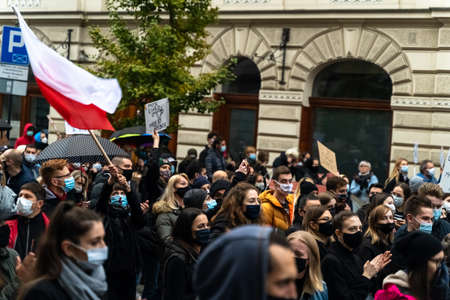 Krakow, Poland - October 25, 2020: Polish people gathered together wearing mask during pandemic in...