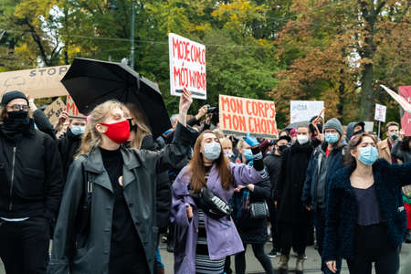 Krakow, Poland - October 25, 2020: Polish people gathered together wearing mask during pandemic in order to protest against a legislative proposal for a total ban of abortion in the main city centerのeditorial素材
