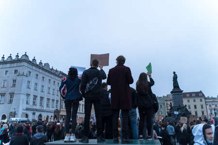 Krakow, Poland - October 25, 2020: Polish people gathered together wearing mask during pandemic in...