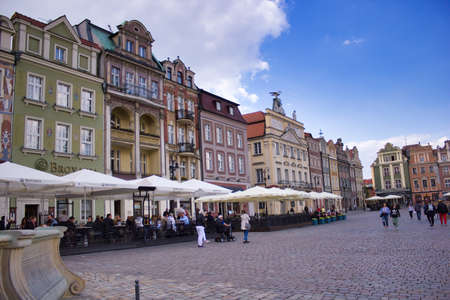Wroclaw, Poland - May 10, 2019: People enjoying leisure activity in the main square city center during summer against cloudy sky. Famous Polish tourist attractionのeditorial素材