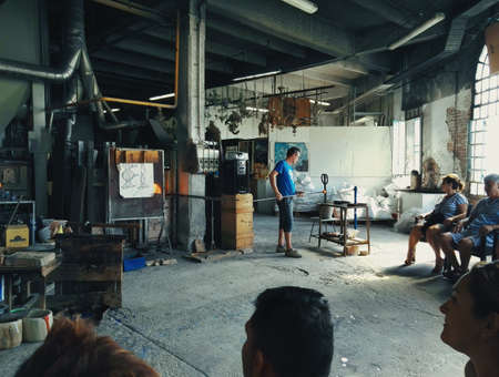 Venice, Italy - September 03, 2018: A glass worker making a glass in front of tourists in a small island called Buranoのeditorial素材