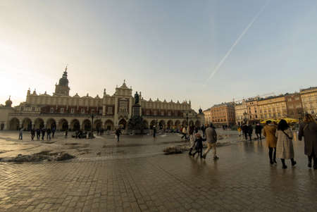 Krakow, Poland - February 22, 2021: Panorama of Cloth Hall (Sukiennice) - located on Main Square (Plac Mariacki) and serving as the handicraft market and people walking in the city centerのeditorial素材