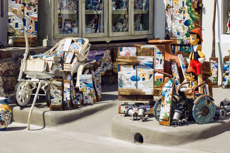 Santorini, Greece - September 11, 2017: Bunch of colorful decoration items and souvenir kept for sale in front of a shop in the commercial market of famous greek islandのeditorial素材