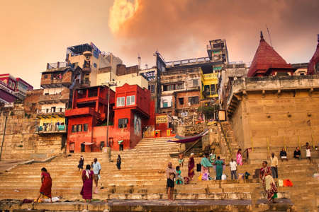 Varanasi, India - November 01, 2016: Narad Ghat on the Ganga River in Uttar Pradesh where People participating in holy rituals and performing daily routine or activities against dramatic cloudsのeditorial素材