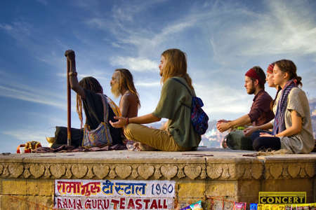 Varanasi, India - November 01, 2016: Bunch of tourists, sadhu baba and pilgrims in sitting posture...