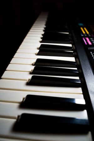 Music concept: close up on a piano keyboard. Vertical image with selective focus. black and white music note keys.の写真素材
