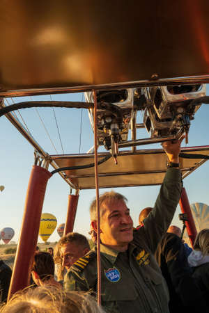 Cappadocia, Turkey - September 14, 2021: A hot air balloon pilot navigates his balloon through the sky near Goreme in the Cappadocia region of Turkey.のeditorial素材