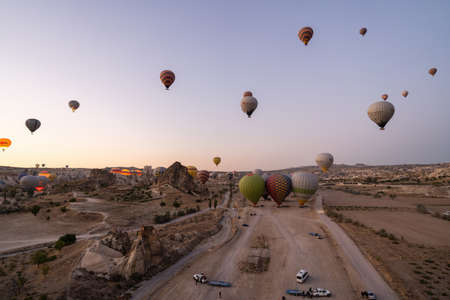 Cappadocia, Turkey - September 14, 2021: Wide angle shot of colorful hot air balloons together floating in the sky at early morning in Goremeのeditorial素材