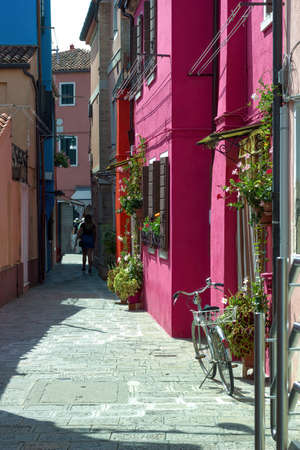 Venice, Italy - September 03, 2018: Narrow street and pink building in burano island located in venezian lagoonのeditorial素材