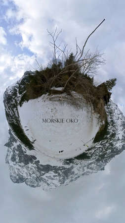Morskie oko, Poland - Text written on a 360 degree view of mountains on a frozen lake with white...