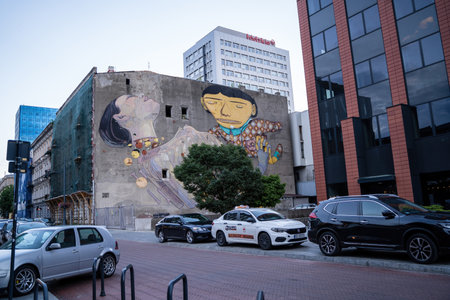 Lodz, Poland - July 08, 2022: A huge garffiti on the wall of building at Pomorska street, Fragment of paintings on the wall, historic tenements Piotrowska Streetのeditorial素材