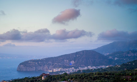 Twilight Over the Sorrento Coastline - A stunning view of the Sorrento coastline at twilight, with distant city lights.の写真素材