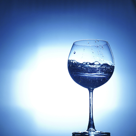 aqua water champagne glass on white blue backgroundの写真素材