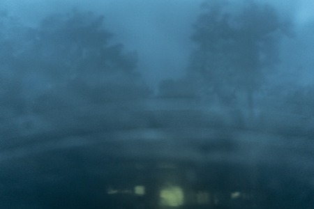 Blurred park with bokeh light a long the road in raining day on natural backgroundの写真素材