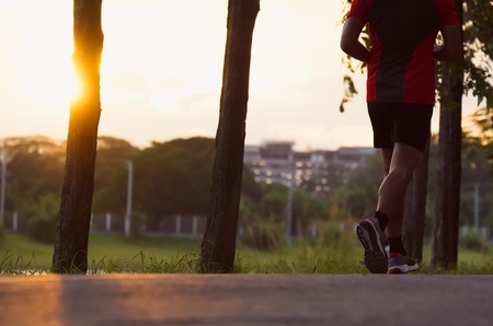 Young man run on street, Runner jogger at city park with exercise fitness dark black color.の写真素材