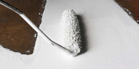 Roller Brush Painting, Worker painting on floor surface wall by the roller brush white paintの写真素材