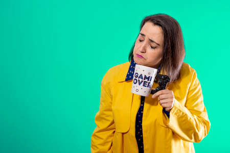 sad young girl with a GAME OVER cup