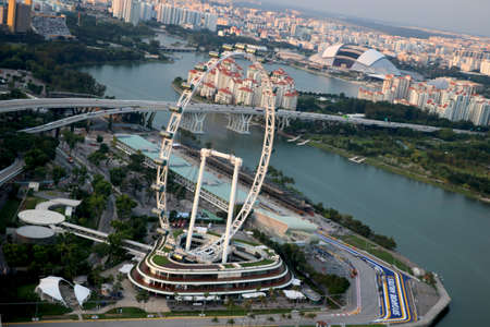 City-Singapore, Country-Singapore 05/10/2020 aerial view of Singapore flyer with background of roads...