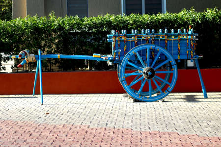 Blue colour bullock cart with yellow, red and green strip park as attractionの写真素材