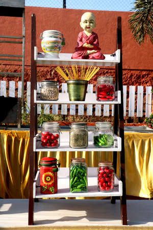 Show piece of Tradition tea pots with artificial food item glass container on wooden rackの写真素材