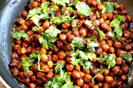 Indian chickpea dish(chana masala) with coriander laves garnish on topの写真素材