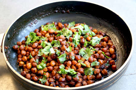 Indian chickpea dish(chana masala) with coriander laves garnish on topの写真素材