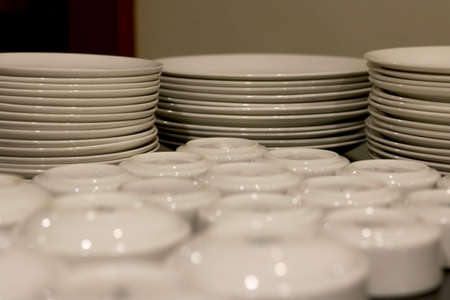 ceramic plates and bowl arrange on table at restaurant dinning hall