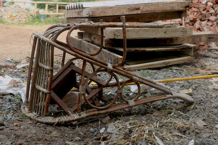 broken and dirty Cane bamboo swing chair on groundの写真素材