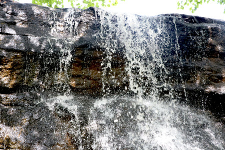 portrait view of water falling from big rock at bilpudi (Gujarat) (India)の写真素材