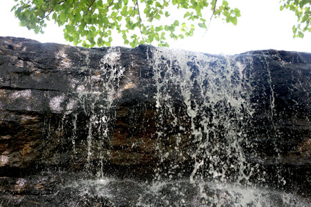 portrait view of water falling from big rock at bilpudi (Gujarat) (India)の写真素材