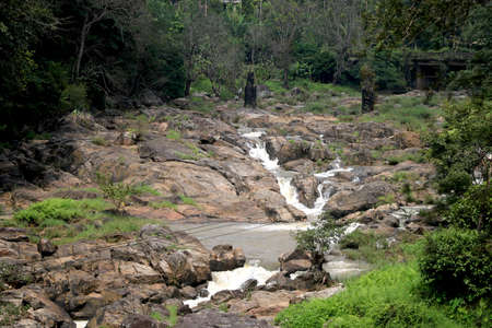 Flowing water from stone in riverの写真素材