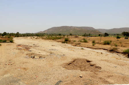 View of dry river in India with background of nature and mountainの写真素材