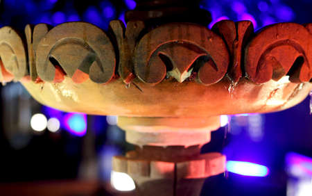 view of antique water fountain of stone with background of light on treeの写真素材