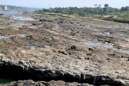 areal view of flowing water in river with big rock during summer in Indiaの写真素材