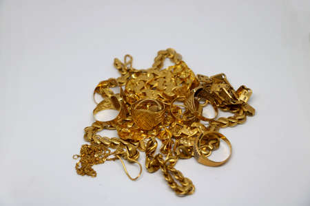 group of different gold chain and rings on isolated backgroundの写真素材
