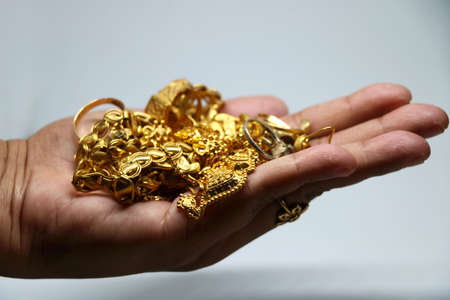 Women hand holding mix Gold jewelery (ornament)の写真素材