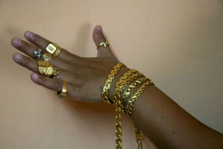 Women hand Wearing mix Gold jewelery (ornament)の写真素材